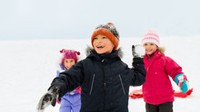 Childhood, Leisure And Season Concept - Group Of Happy Little Kids In Winter Clothes Playing Outdoors