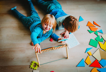 Wall Mural - little boy and girl learn to write and calculate numbers