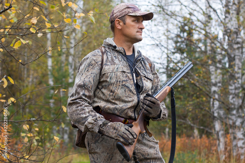 hunter with gun in the birch forest Tableau sur Toile