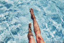 Low Section Of Woman's Legs In Swimming Pool