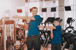 © VadimGuzhva - Young Father and Son Preparing for Training in Gym