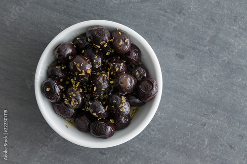 Fotografie, Obraz Grade A black olives seasoned with fresh herbs