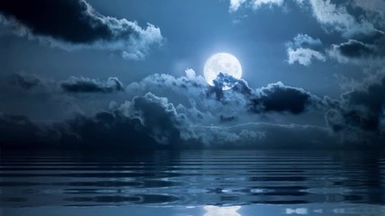Wall Mural - full moon in clouds over ocean loopable animation
