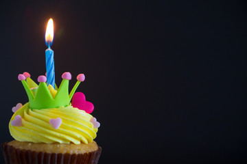 Birthday cupcake with a single blue candle.Cupcake with yellow cream and heart for love valentines.green crown cupcakes with cream cheese frosting and a red heart. Beautiful and delicious cupcake.