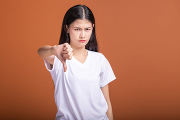 Wall Mural - Upset woman isolated over orange background.