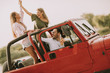 © BGStock72 - Happy friends having fun in convertible car at vacation