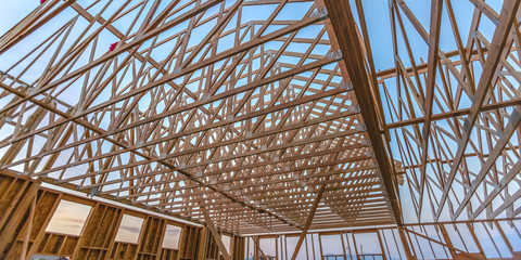 Wall Mural - Looking up at new wood beams of building wide pano