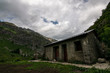 Scenic little cabin in the middle of a vast valley surrounded by mountains. Pyrenees (Huesca, northern Spain)