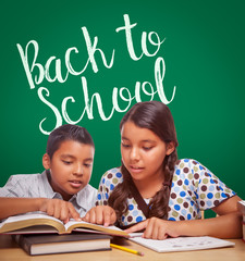 Wall Mural - Back To School Written On Chalk Board Behind Hispanic Boy and Girl Having Fun Studying Together