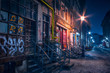 Beautiful old alley with old buildings shot in the night well illuminated by street lamps