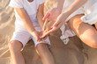 © Svetlana - the hands of the child and mother. mom pours sand on the child's hands. playing with baby. sand. summer. desert