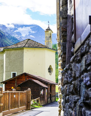 Wall Mural - church in Lillaz, Val d'Aosta, Italy and glimpse of Gran Paradiso in the background