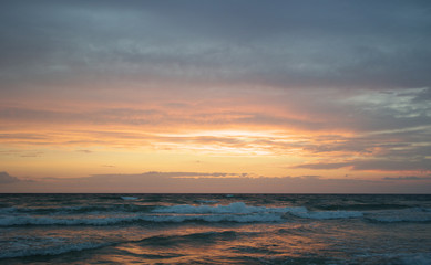  Beach at sunset with big clouds and colors in Salento - Italy