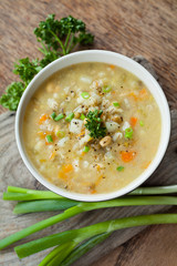 Wall Mural - Winter earthy healthy soup with vegetables: carrot, potato, parsnip, onion, garlic and grains barley sand lentils.