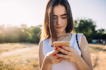 Close-up portrait of young woman using smart phone