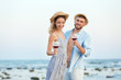 © New Africa - Young couple with glasses of wine on beach