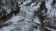 Aerial Drone Footage Of Chittenango Falls During The Winter. The Snow Melt On This Warm Day Resulted In The Strong Current. I Flew My Drone Over The Iconic Bridge Located In Cazenozia, New York