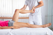 Male Therapist Stretching Woman's Leg