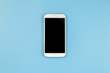 Mobile phone on blue background pastel style flatlay topview copyspace clipping path at screen