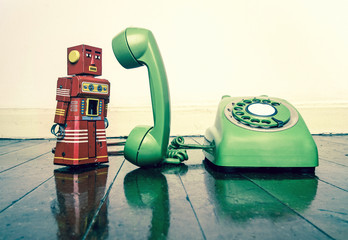 Wall Mural - vintage  red obot on the phone standing on a old wooden f