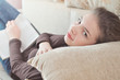 © xzgorik - Young Female Student reading book relaxing at home