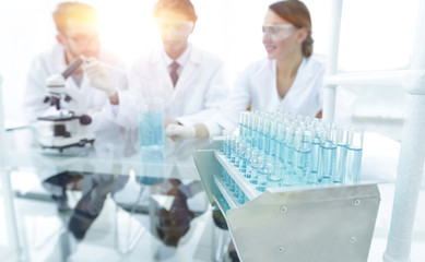 Wall Mural - background image of scientists studying blue liquid in a flask