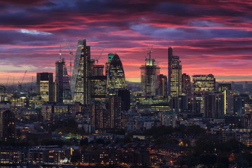 Fototapete - Die beleuchtete City von London nach Sonnenuntergang am Abend mit rotem Himmel und Wolken, Großbritannien