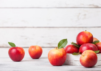 Wall Mural - Braeburn pink lady apples in wooden box on white wooden background