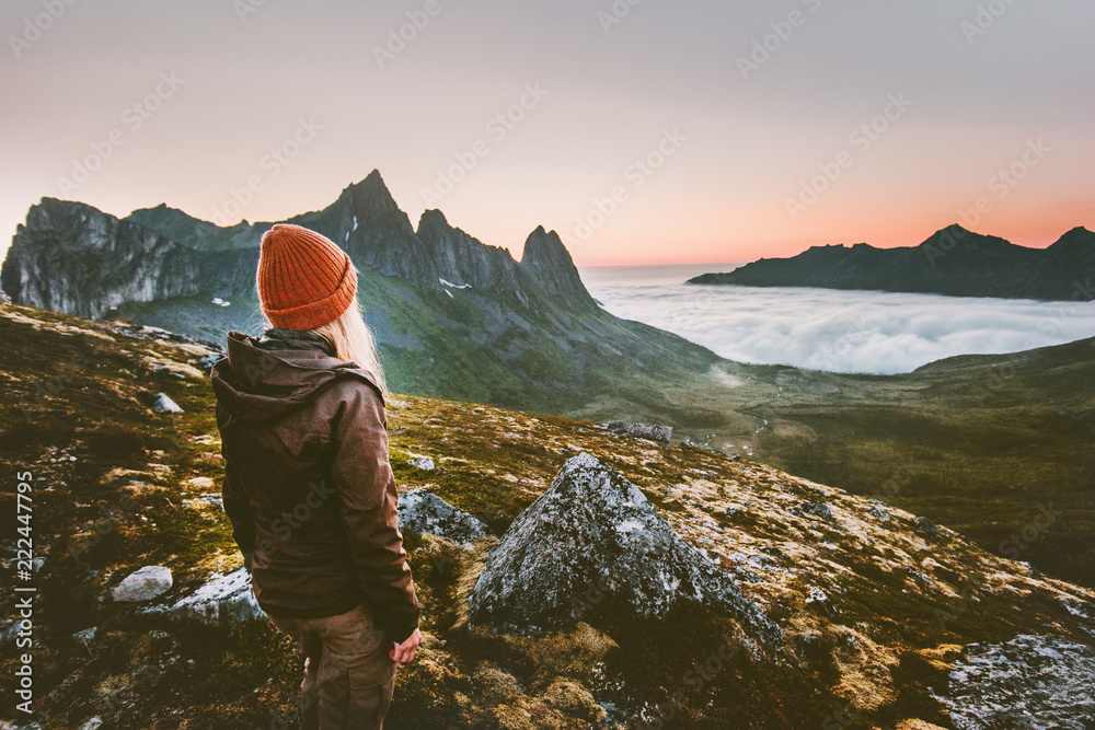 Woman tourist hiking survival in mountains alone outdoor active lifestyle travel adventure extreme vacations sunset Norway landscape - obrazy, fototapety, plakaty 