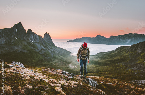 Man hiking survival in mountains alone outdoor active lifestyle travel adventure extreme vacations sunset Norway landscape