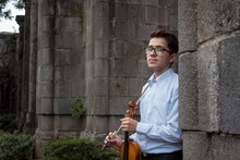 Portrait Of Young Violinist Outside The Castle