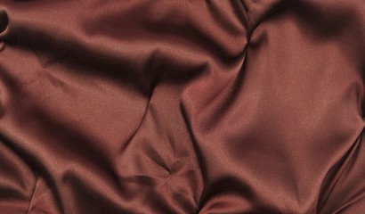 Chocolate-colored satin, drapery, textile background