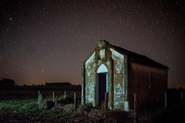Wall Mural - Church in the foreground in starry night.