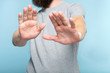© golubovy - no thanks. rejection refusal and denial. man putting hands forward as if pushing smth away palms in foreground. cropped portrait of a bearded guy on blue background.
