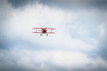 Vintage Red Propeller Plane Flying On A Blue Sky