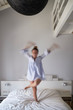 © ADDICTIVE STOCK - Blurred woman jumping on bed