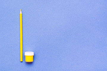 Wall Mural - Objects for drawing - yellow pencil and yellow gouache on a blue background. Top View. Copy space