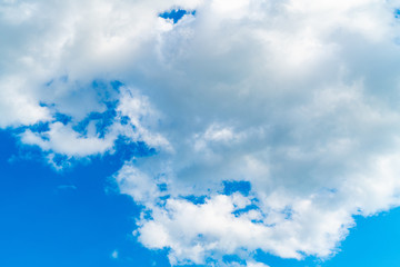 puffy clouds with bright blue sky