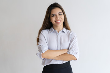 Wall Mural - Happy successful young manager portrait. Beautiful mix raced woman in casual shirt posing with arms folded. Business success concept