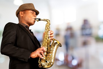 Wall Mural - Close-up man playing on saxophone on background