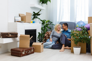 Wall Mural - Mortgage, people and real estate concept - happy couple with boxes moving to new home