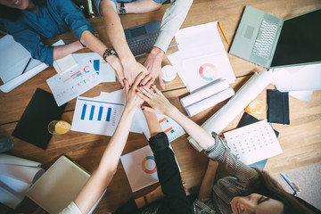 Team of colleagues with their hands in top view.