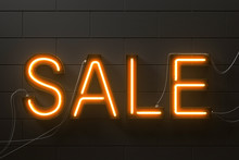 Neon Orange Sale Sign On Black Brick Wall
