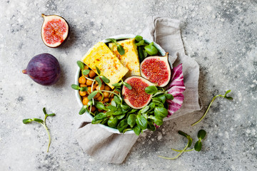 Wall Mural - Vegan, detox Buddha bowl recipe with turmeric roasted tofu, figs, chickpeas and greens. Top view, flat lay, copy space