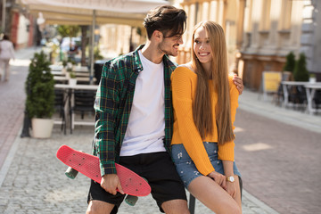 Happy couple with skateboards having fun.