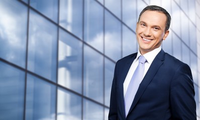 Portrait of happy businessman on background