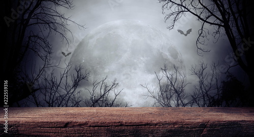 Fotografía Old wood table and silhouette dead tree at night for Halloween background