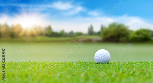 White Golf ball on green course to be shot on blurred beautiful landscape of golf course in bright day time with copy space. Sport, Recreation, Relax in holiday concept