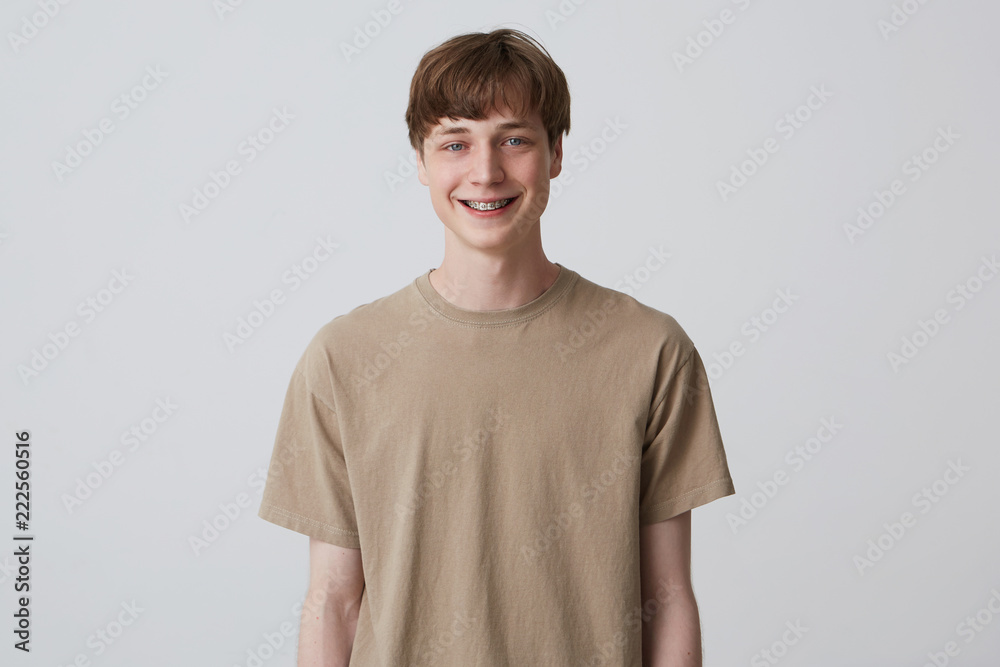Studio portrait of smiling handsome young man with healthy teeth and ...