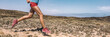 © Maridav - Sport exercise fitness female athlete runner running on trail run race in desert panorama banner. Closeup of legs and running shoes.